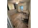 Comfortable bedroom with wood-look floors, built-in storage, and large windows providing ample natural light at 508 51St W Ave, Bradenton, FL 34207