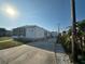 Exterior view of home with a long driveway, screened porch, and storage shed at 508 51St W Ave, Bradenton, FL 34207