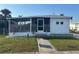Charming home featuring a screened-in porch, well-maintained lawn, and a welcoming entrance at 508 51St W Ave, Bradenton, FL 34207