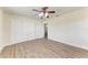 Bedroom featuring wood floors, a ceiling fan, and closet with sliding doors at 5616 33Rd E St, Bradenton, FL 34203