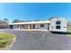 Single story home with an elongated paved driveway and brick porch at 5616 33Rd E St, Bradenton, FL 34203