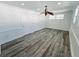 A bedroom featuring wood-look floors, two windows, two closets, white walls and trim, and a ceiling fan at 611 19Th W Ave, Palmetto, FL 34221