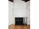 Elegant white-brick fireplace with decorative mantel and black screen, adding a cozy touch to the home at 611 19Th W Ave, Palmetto, FL 34221