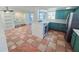 Kitchen featuring teal cabinets, stainless appliances, and tile flooring at 611 19Th W Ave, Palmetto, FL 34221