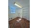 A laundry room with herringbone pattern floor, white walls, a window, and built-in shelving at 611 19Th W Ave, Palmetto, FL 34221