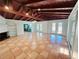 Spacious living room with wood-beamed ceiling, tiled floors, and french doors offering ample natural light at 611 19Th W Ave, Palmetto, FL 34221
