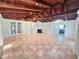 Open living space with tile flooring, fireplace, and French doors leading outside, adjacent to the kitchen at 611 19Th W Ave, Palmetto, FL 34221