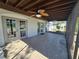 Screened-in patio with ceiling fans, tiled floor, and access to the backyard through glass doors at 611 19Th W Ave, Palmetto, FL 34221