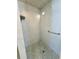 The tiled shower features a built-in seat, a handheld showerhead, and a grab bar at 611 19Th W Ave, Palmetto, FL 34221