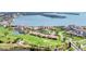 Aerial view of a waterfront golf community featuring residential buildings, a pool, and bay views at 6158 Palma Del Mar S Blvd # 504, St Petersburg, FL 33715