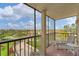 Balcony view with chairs looking out to roads, trees, and some buildings at 6158 Palma Del Mar S Blvd # 504, St Petersburg, FL 33715