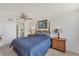 This bedroom features carpeted floors, ceiling fan and two wooden nightstands at 6158 Palma Del Mar S Blvd # 504, St Petersburg, FL 33715