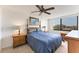 Cozy bedroom with a queen bed, ceiling fan and a view from a large window at 6158 Palma Del Mar S Blvd # 504, St Petersburg, FL 33715