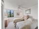 Bright bedroom with two beds, ceiling fan and a large window at 6158 Palma Del Mar S Blvd # 504, St Petersburg, FL 33715