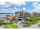Exterior view of a condo complex featuring lush landscaping, parking, and water views at 6158 Palma Del Mar S Blvd # 504, St Petersburg, FL 33715