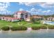 Beautiful waterfront condo community with lush landscaping and a sandy beach area at 6158 Palma Del Mar S Blvd # 504, St Petersburg, FL 33715
