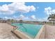 Community pool with clear blue water and lounge chairs overlooking the water at 6158 Palma Del Mar S Blvd # 504, St Petersburg, FL 33715