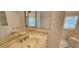 Primary bathroom with soaking tub, tiled shower, and marble countertop at 629 Sawgrass Bridge Rd, Venice, FL 34292