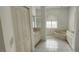Bathroom featuring tile floors, a large tub, double sinks, and a walk-in shower at 629 Sawgrass Bridge Rd, Venice, FL 34292