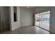 Bedroom with tile floors and sliding glass doors leading to pool and backyard at 629 Sawgrass Bridge Rd, Venice, FL 34292