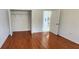 Bedroom with hardwood floors and closet leading to a kitchen at 629 Sawgrass Bridge Rd, Venice, FL 34292