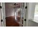 Bedroom with hardwood floors, plantation shutters and french doors at 629 Sawgrass Bridge Rd, Venice, FL 34292