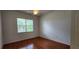 Bright bedroom with hardwood floors, a ceiling fan, and a window bringing in natural light at 629 Sawgrass Bridge Rd, Venice, FL 34292