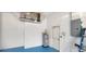 Spacious garage with blue epoxy floor, water heater, and electrical panel at 629 Sawgrass Bridge Rd, Venice, FL 34292