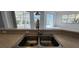 Close up of kitchen sink and faucet with pool views at 629 Sawgrass Bridge Rd, Venice, FL 34292