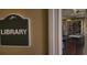 Library sign outside a well-appointed room featuring a ping pong table and book cases at 629 Sawgrass Bridge Rd, Venice, FL 34292