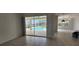 Open living area with sliding glass doors overlooking the outdoor pool area at 629 Sawgrass Bridge Rd, Venice, FL 34292
