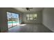 An empty living room features tile flooring and natural light at 629 Sawgrass Bridge Rd, Venice, FL 34292