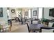 Community meeting room features an elegant fireplace, tables, and chairs for gathering at 629 Sawgrass Bridge Rd, Venice, FL 34292