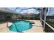 Spacious screened-in pool area with spa, ideal for relaxation and entertaining with views of neighboring homes at 629 Sawgrass Bridge Rd, Venice, FL 34292