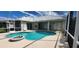 Beautiful screened-in pool with an attached spa, complemented by a covered lanai for outdoor enjoyment at 629 Sawgrass Bridge Rd, Venice, FL 34292