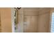 Tiled walk-in shower featuring glass enclosure and tile surround at 629 Sawgrass Bridge Rd, Venice, FL 34292