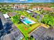 Wide aerial shot of an apartment complex showcasing amenities, parking, and verdant landscaping at 6503 Stone River Rd # 305, Bradenton, FL 34203