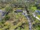 Aerial view of the property including the home, surrounded by lush landscaping and mature trees at 7000 Wild Horse Cir, Sarasota, FL 34241