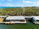 Single-story home with metal roof, waterfront access, and private dock with a view of the bay at 713 Saint Judes S Dr # 1, Longboat Key, FL 34228