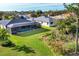 An aerial view of a pristine backyard with a screened-in pool, surrounded by lush green landscaping at 7415 Loblolly Bay Trl, Lakewood Ranch, FL 34202