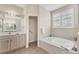 Light and airy bathroom featuring a soaking tub and a separate shower at 7415 Loblolly Bay Trl, Lakewood Ranch, FL 34202