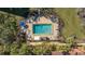 Aerial view of the community pool with lounge chairs and tables for residents at 8635 Midnight Pass Rd # 206C, Sarasota, FL 34242