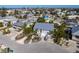 Stunning aerial view of a coastal home featuring lush landscaping and a metal roof at 9 Palm Harbor Dr, Holmes Beach, FL 34217