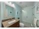 Bathroom features white subway tiles in the shower with a dark vanity and decorative mirror at 9 Palm Harbor Dr, Holmes Beach, FL 34217