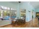 Bright breakfast nook with a glass table, wicker chairs, and views of the screened-in porch at 9 Palm Harbor Dr, Holmes Beach, FL 34217