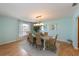 Bright dining room with a wooden table, stylish chairs, and modern lighting at 9 Palm Harbor Dr, Holmes Beach, FL 34217