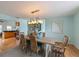 Dining room with a large table, decorative lighting, and adjacent to kitchen at 9 Palm Harbor Dr, Holmes Beach, FL 34217