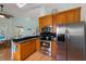 Kitchen featuring stainless steel appliances, granite countertops, and wooden cabinets at 9 Palm Harbor Dr, Holmes Beach, FL 34217