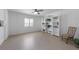 Bright living room featuring neutral flooring, white walls, and a decorative bookcase at 9 Palm Harbor Dr, Holmes Beach, FL 34217