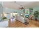 Bright living room with hardwood floors, coastal decor, and access to a patio at 9 Palm Harbor Dr, Holmes Beach, FL 34217
